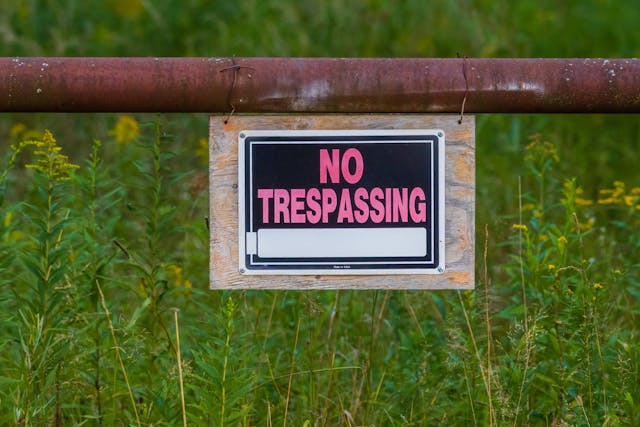 No trespassing sign A 'No Trespassing' sign in front of a field