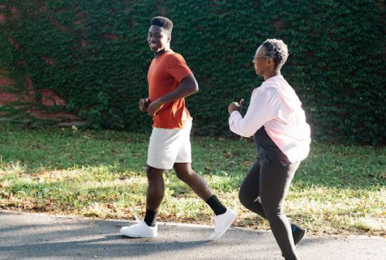 Two people jogging together on a path outside