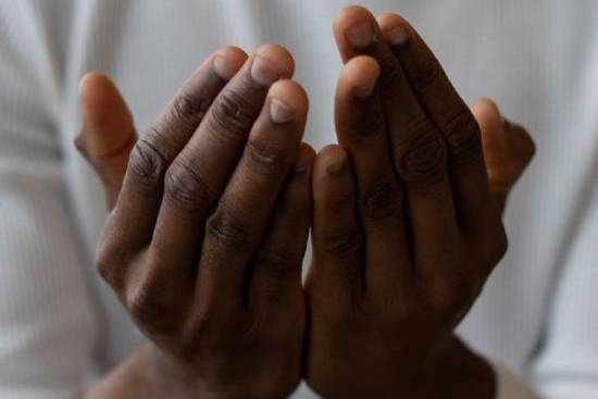 Hands uplifted in prayer