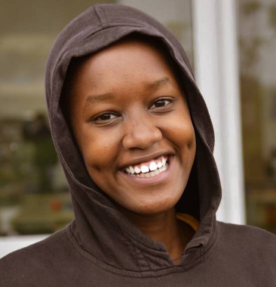 A smiling and hopeful young woman navigating the challenges of unemployment with faith and purpose.