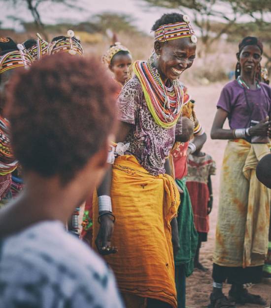 A tribe elder performing a cultural dance with others