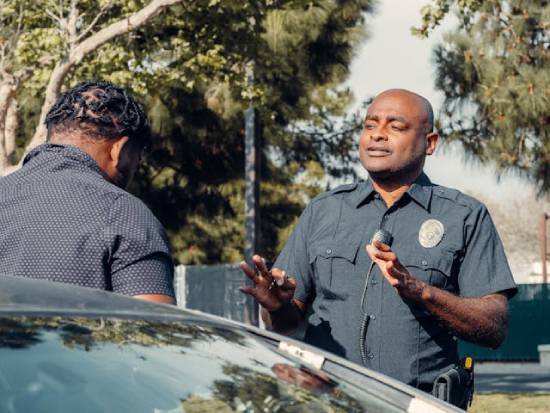A police officer speaking to a car driver