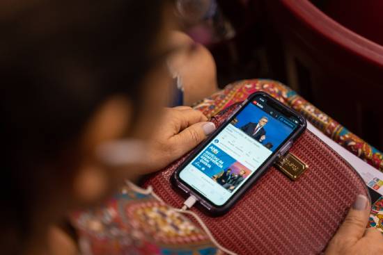 A Christian faithful who cannot attand an in-person church program following through a livestream.