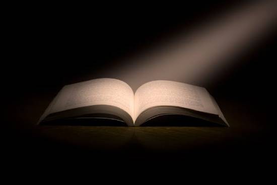 An open book with a light beam shining on it. This illustrates Solomon's desire for wisdom from God.