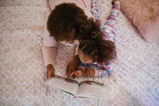 Bedtime Stories A mother and daughter reading bedtime stories as part of their bedtime routine.