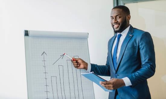 A businessman pointing to a chart depicting market trends