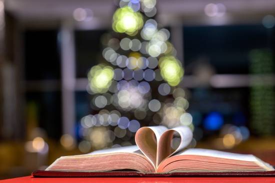 Open Bible An open Bible with a two pages folden inro a heart shape.