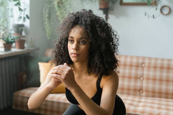 A health conscious woman doing squat exercise as part her routine to care for her body.