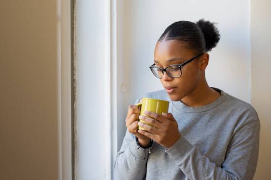 A woman taking a hot drink during her prayer and fasting season.