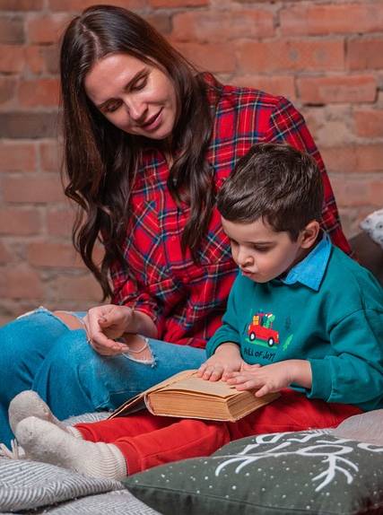 Mother and son happily reading the Bible.