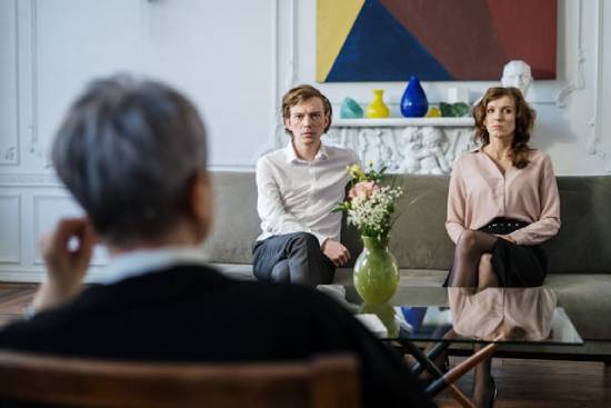 Marital Counseling A disagreeing couple being attended to by a christian marriage counsellor.