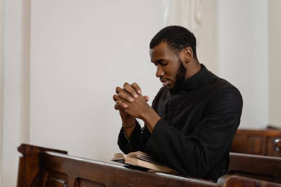 Man Meditating on Bible Promises and Praying A man meditating on Bible promises as he seeks God in prayer.