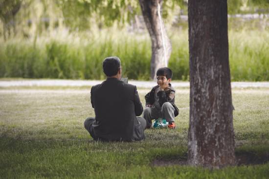 Father and Son Talking Father correcting his son constructively and with love to help him appreciate the biblical example of correcting in love.