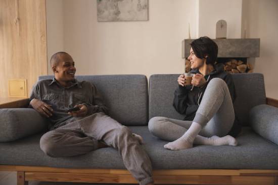 A Couple's Conversation A couple having safe conversations at home on a couch.