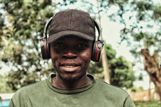 Gentleman Listening to Music A happy genetleman listening to uplifting music using a headphones as he go about his business.