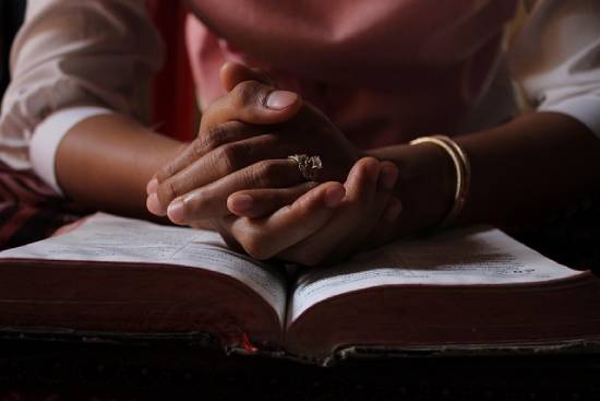 Bible Study A person reading the Bible to know what it says about God's forginess.