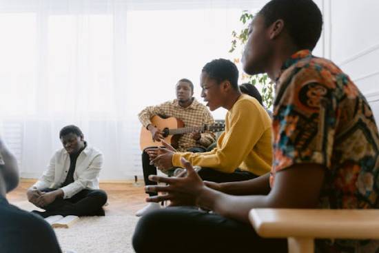 A Christian Prayer Band Christians who are members of a prayer band meeting together for Bible study, worship, and prayer.