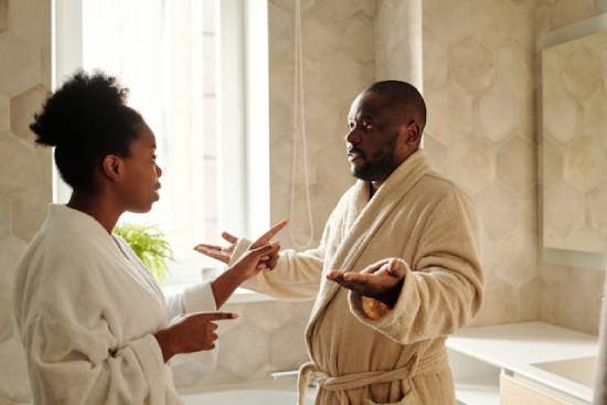 A couple arguing in the bathroom over selfcare routine.
