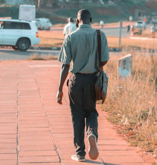 A Man Going to Work A man carrying a handbag walking to work.