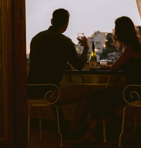 Couple Taking Liquor A couple taking liquor together in a pub at dusk.