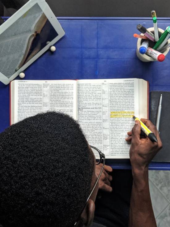 A man diligently practising his daily Bible study routine as a way of growing closer to God.