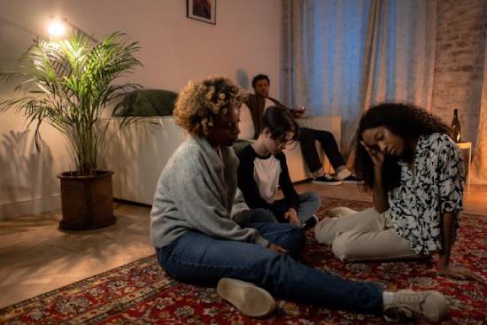 A family sitting in the living rooms solving family problems.