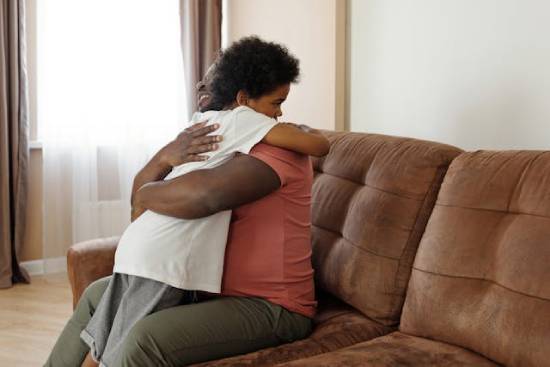 A father hugs his daughter A father hugs his daughter after he apologizes for doing something hurtful