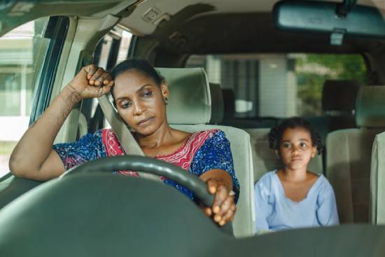 Mother Opening Up to Daughter A disturbed mother opening up to her daughter while travelling together in a car.