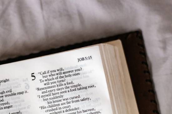An open bible displaying the book of job chapter 5.