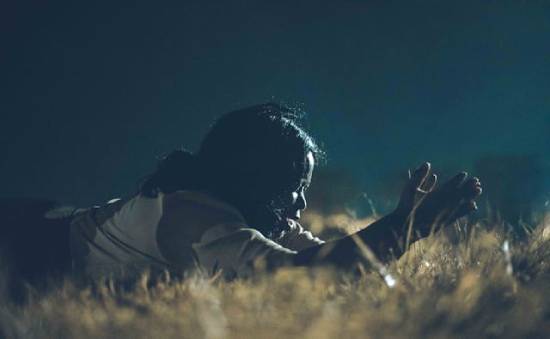 A Woman Praying Prostrate A woman lying prostrate in surrender to God while making her prayers.