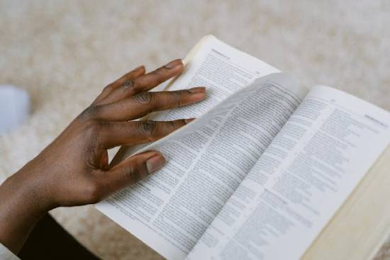 A Person Flipping the Bible A person flipping the pages of the Bible to learn about boundaries.