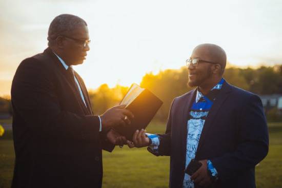 Two preachers having a discussion on the biblical teaching on salvation and new birth.