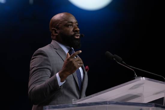 A pastor ina grey suit peachingba sermon on overcoming setbacks and how to get a new start.